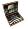 A set of twelve Edwardian silver fruit knives and forks, by The Goldsmiths and Silversmiths Company, London 1906, the blade with an engraved border, tapering mother-of-pearl handles, in a fitted wooden case.