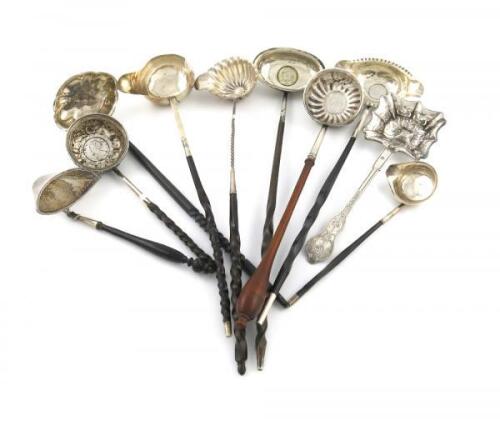 ëA mixed lot of silver flatware, comprising: a 19th century Dutch sifting spoon, a French sifting spoon, a toddy ladle, plus seven various punch ladles, with twisted whale-bone, wood and plastic handles, two of the bowls set with coins, approx. weight 9oz