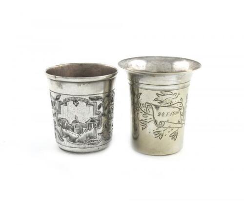 A 19th century silver and niello work beaker, assay master Andrey Kovalskiy, Moscow 1855, tapering circular form, with a townscape scene and foliate decoration, height 6.2cm, plus an electroplated beaker. (2)