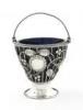 A George III silver swing-handled sugar basket, by Daniel Bates, London 1773, circular wire-work form, rope work borders and swing-handle, blue glass liner, height 8.5cm, approx. weight 3oz.