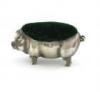 An Edwardian novelty silver pig pin cushion, by Levi and Salaman, Birmingham 1905, modelled in a standing position, green velvet cushion, length 5.5cm.