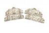 A matched set of four silver menu card holders, two by Brook and Son, Edinburgh 1891, two unmarked, shaped form, pierced and embossed with cherubs and foliate scroll decoration, inscribed, length 8cm, approx. weight 3.6oz. (4)