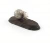 By Patrick Mavros, a Zimbabwean silver model of dung beetle at work, with his initials and Zimbabwean hallmarks, modelled pushing a ball of dung, on a wooden stand, total length a swimming position, length 18cm.