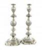 A large pair of silver Sabbath candlesticks, probably by Morris Salkind or Morris Sternberg, London 1915, baluster form, embossed decoration, lacking drip pans, on a shaped square base, height 36cm, approx. weight 32.3oz. (2)