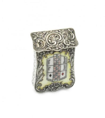 A French silver and enamel vesta case, circa 1900, shaped rectangular form, foliate scroll decoration, slanted hinged cover, the front enamelled with a roulette table, striker to the base, length 5cm, approx. weight 1.1oz.