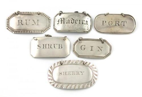 A collection of five Scottish silver wine labels, various designs, dates and makers incised 'SHRUB', 'PORT', 'GIN', 'MADEIRA' and 'SHERRY', plus an Irish silver wine label, incised 'RUM', approx. weight 2oz. (6)