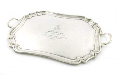 An Edwardian silver two-handled tray, by The Goldsmiths and Silversmiths Company, London 1908, rectangular form, canted corners, moulded border, inscribed with a regiment badge and 'Presented to the Officers P.W.O.R.R Wiltshire Yeomanry by The Hon. Lt. C