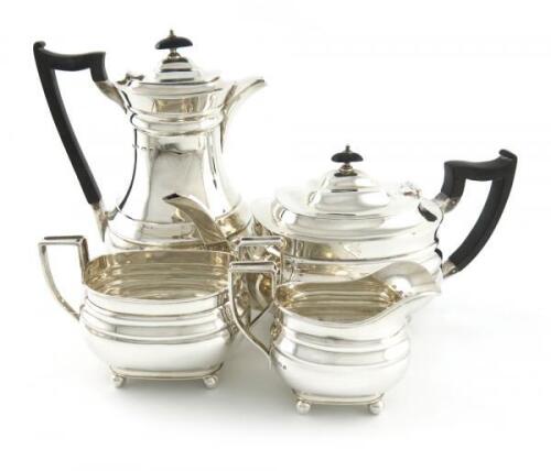 A four-piece silver tea set, by James Dixon and Sons, Sheffield 1932/33, oblong bellied form, scroll handles, on four ball feet, length handle to spout 28cm, approx. weight 58oz. (4)