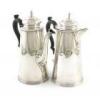 A pair of silver café au lait pots, by H. Woodward and Co, London 1910, tapering circular form, scroll handles, domed hinged covers with knop finials, height 20cm, approx. weight 28oz. (2)