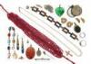 A leather jewellery casket containing assorted items of jewellery, including a string of faceted ruby beads, a cultured pearl necklace, a spinning gold fob seal, a Scottish banded agate silver tank track bracelet, a multicoloured paste bracelet set in gil