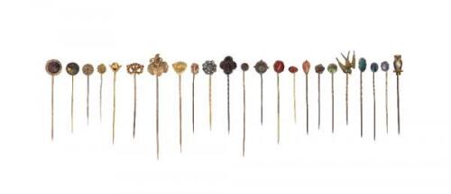 Twenty-three assorted stick pins, of various designs including an owl, a dogs mask and some set with assorted gemstones including a topaz From the collection of Bernard Watney.