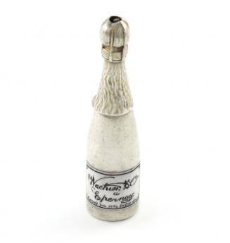 A Victorian novelty silver and enamel pencil, unmarked, modelled as champagne bottle, enamelled label, with a ring attachment, length 6.2cm. Provenance: The KB Collection of Pencils. Illustrated in Bull, K., The KB Collection of Pencils, private publicat