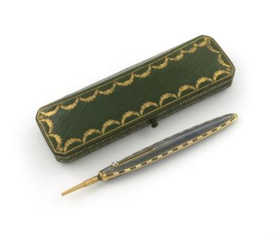 A French gold and enamel pencil, by Cartier, Paris, feather quill form, with grey enamel decoration and a gold and white enamel bead border, with a moonstone slider, in a fitted Cartier case, the underside with 'Cartier 13, Rue de la Paix, and 4, Burlingt