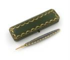 A French gold and enamel pencil, by Cartier, Paris, feather quill form, with grey enamel decoration and a gold and white enamel bead border, with a moonstone slider, in a fitted Cartier case, the underside with 'Cartier 13, Rue de la Paix, and 4, Burlingt