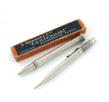 A Mordan Centenary silver pencil, London 1915, also marked patent, the finial with a pencil reserve, length 11cm, plus a Mordan Centennial silver pencil, London 1921, also marked 'S. Mordan and Co., Pat. App. For "Centennial" Rd. 683188', with a cardboa